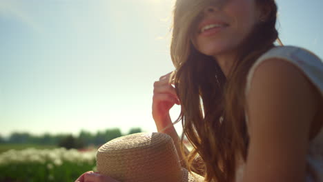 Portrait-of-playful-girl-smiling-in-sun-reflection.-Young-woman-playing-hair.