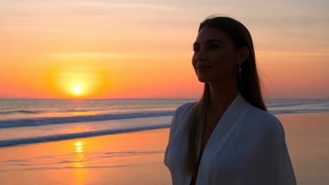 Woman enjoying a beautiful sunset on a beach