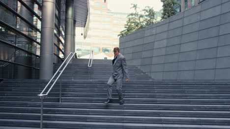 Contemporary-funky-caucasian-businessman-street-dancer-dancing-freestyle-in-the-city