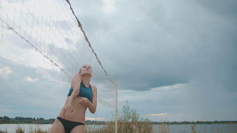 beach volleyball match of two women teams at summer day slow motion shot sportswomen are jumping and playing with ball