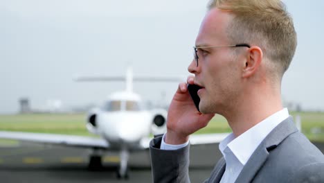 Businessman-talking-on-mobile-phone-at-terminal-4k