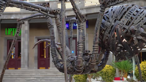 mechanical spider sculpture in urban setting