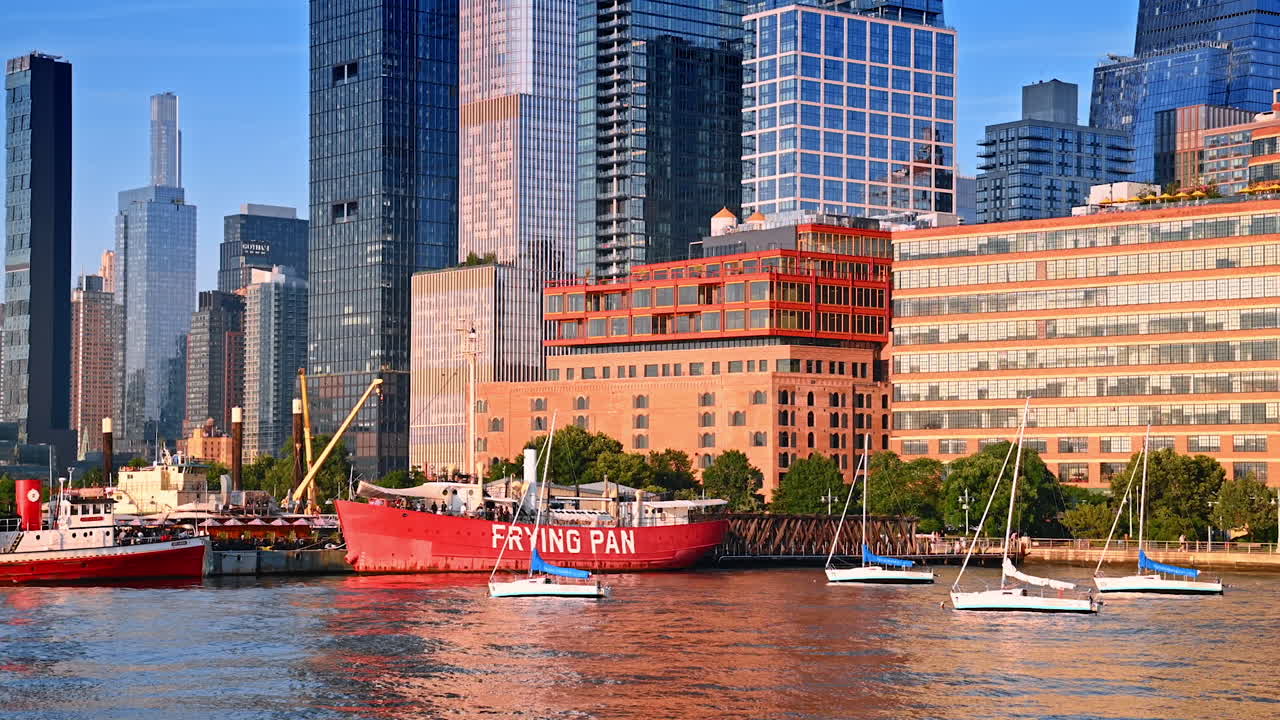 New York, USA, 4 August 2025: Hudson River view with Frying Pan ship and Manhattan skyscrapers. Scenic view of the Hudson River with the historic Frying Pan ship