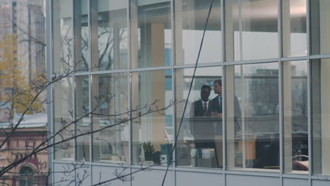 two men having a drink in the office