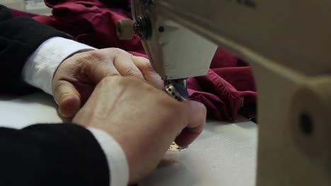 The-Tailor-Sews-Fabric-On-The-Sewing-Workshoo