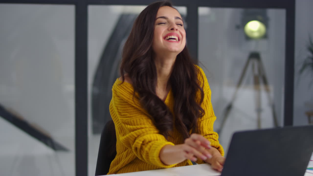 Close-up view of joyful woman chatting notebook in office