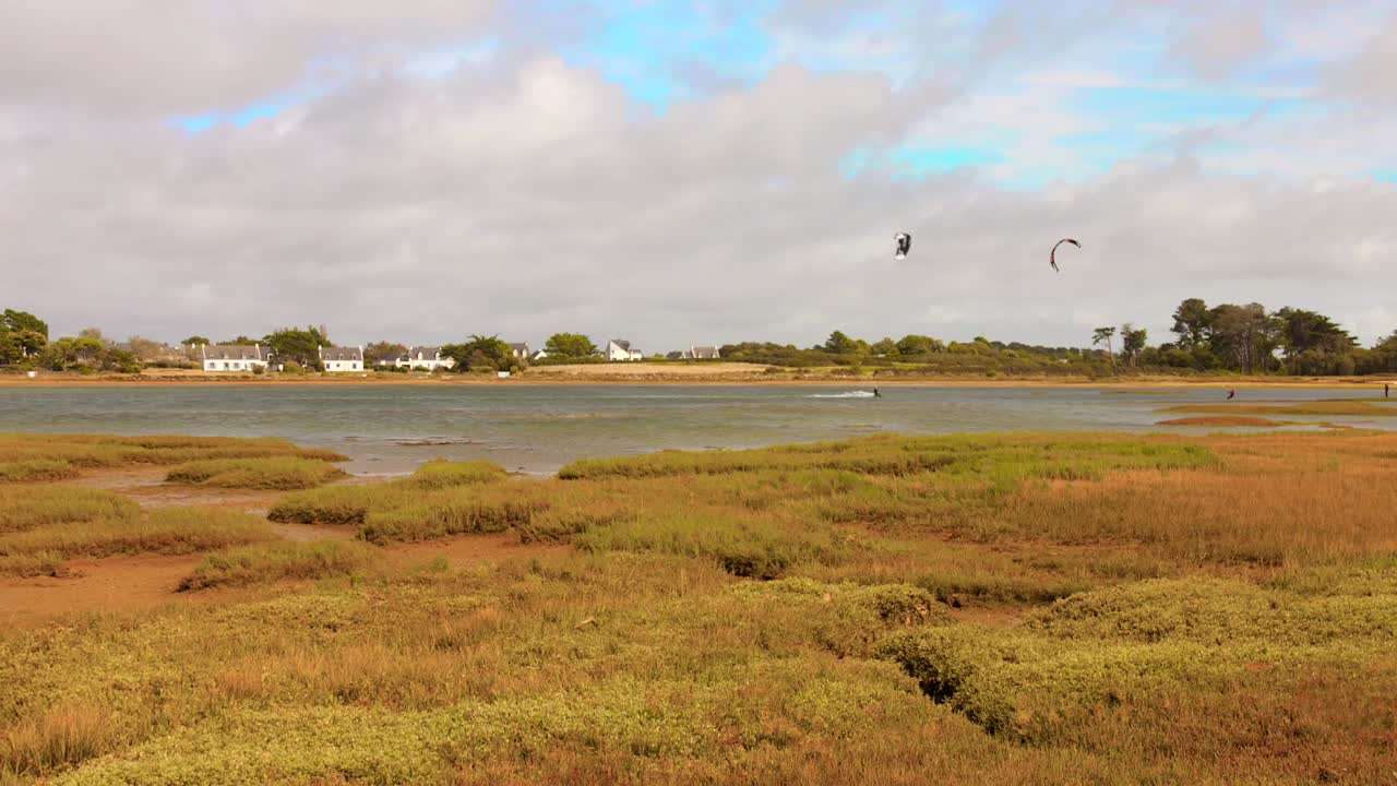 Tourists Kitesurfing At The Beach Of The Gulf Of Morbihan In France. Static Shot