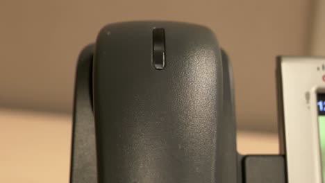 an extreme close up of a hand slamming an office phone down