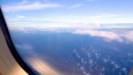 bright and beautiful blue sky landscape, higher floating movement clouds and sun, space layer by layer, shoot an airplane window