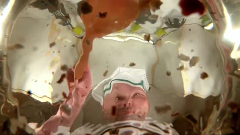 chef prepares vegetable broth. chef adds spice to the soup, the view from the pan in slow motion.