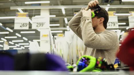 man trying on ski goggles in a store