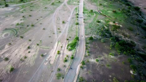 Riders-With-Motorcycles-Traveling-In-Rural-Magadi,-Kenya---aerial-drone-shot