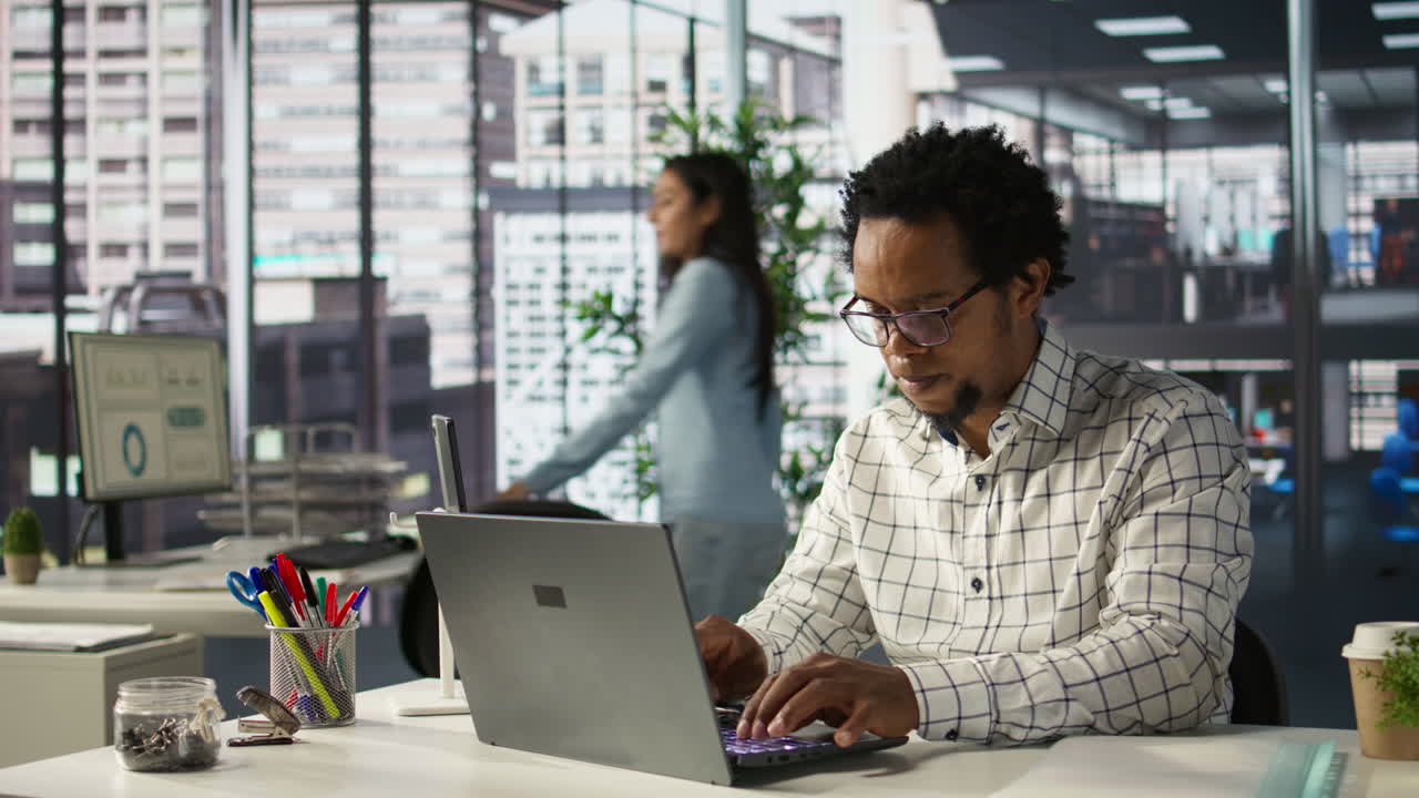 A man working on a laptop in an office