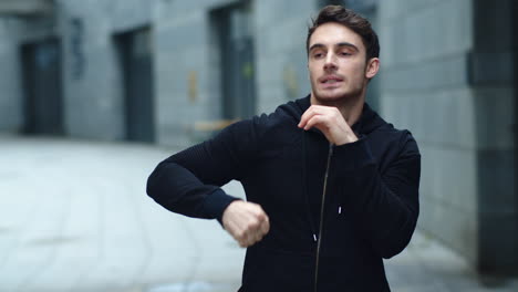 fitness man warming up arms on outdoor. male athlete doing warm up exercises