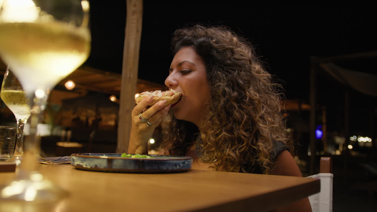 Woman Starting The Dinner With An Appetizer At The Night Beach Resort