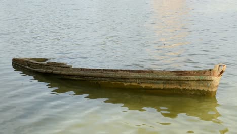 old broken boat sunked in the lake