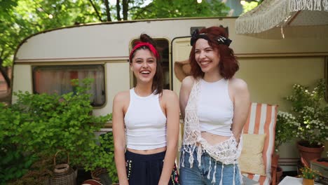 two women enjoying time outdoors near a camper