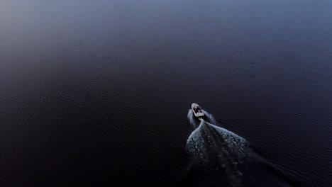 A-boat-ride-through-the-beautiful-waters-of-the-Charzykowskie-Lake-in-Charzykowy,-Poland---aerial