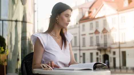 Young-fashionable-woman-sitting-outdoors