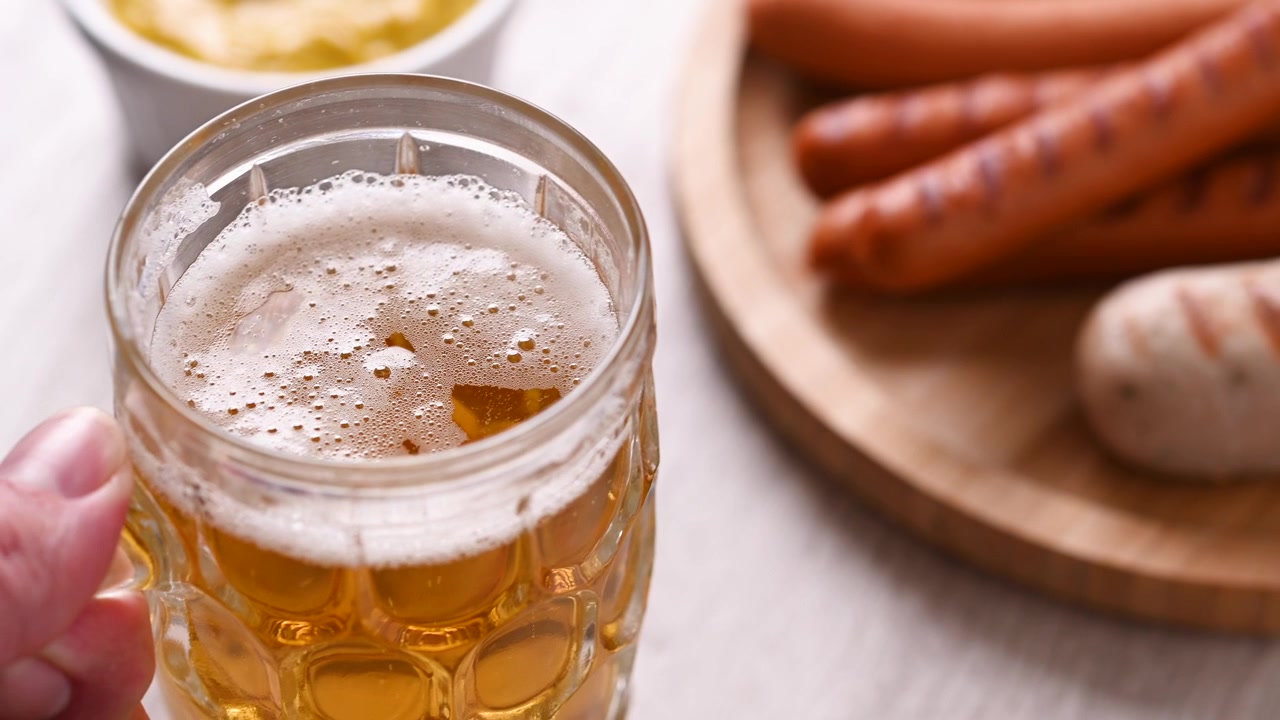 Boccale di Birra su Tavolo con Salsicce per l'Oktoberfest
