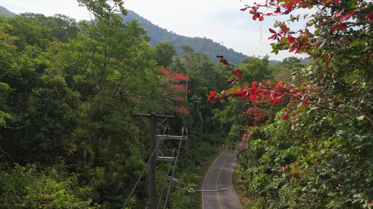Aerial drone footage capturing the tranquil Bailan Village, beach, and tropical resorts on Koh Chang, Thailand