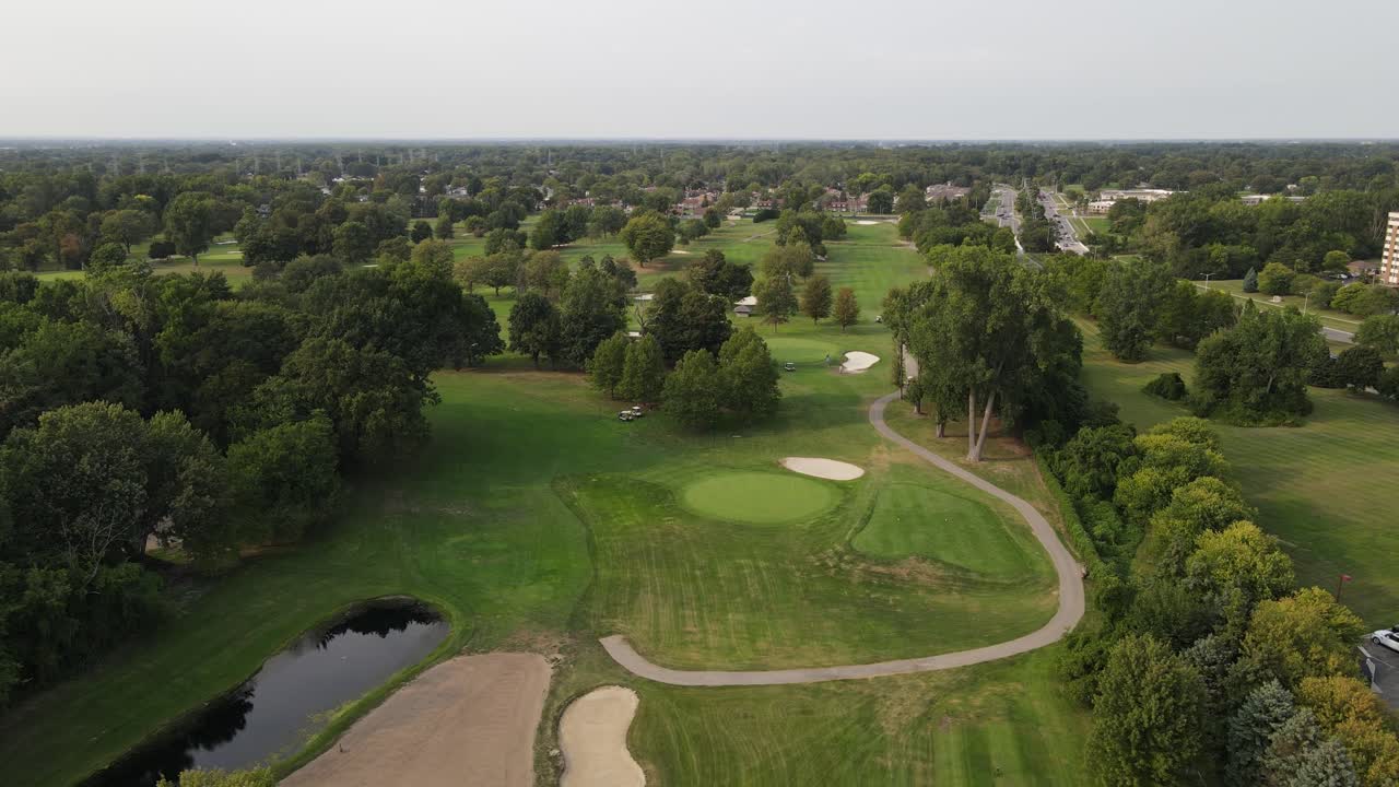 거대한  ⁇ 에서 나무 근처에 주차된 골프 카트, 공중 드론 뷰, 스털링 하이츠 미시간의 플럼 브룩 골프 코스