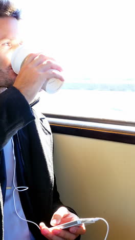 businessman listening to music while having coffee