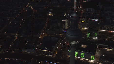 AERIAL:-Over-Berlin-Germany-TV-Tower-Alexanderplatz-at-Night-with-City-Lights-traffic