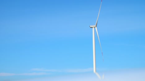 la turbina eólica produce energía en una estación en alta mar en la niebla