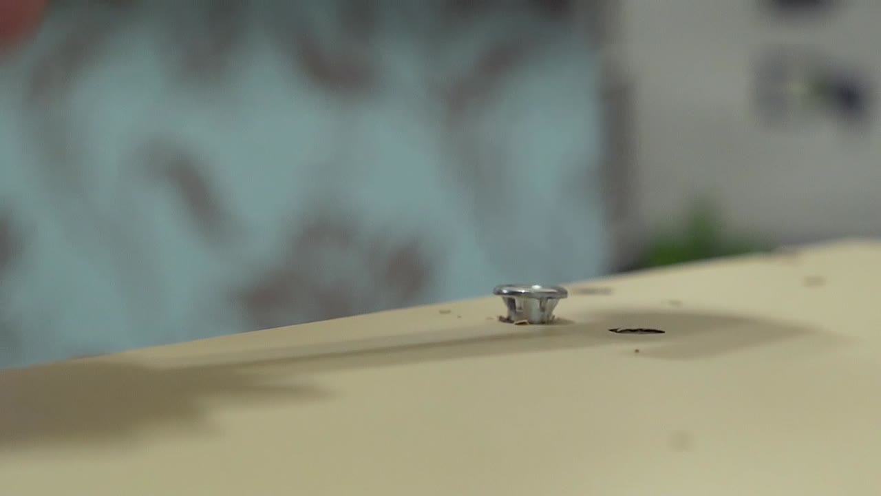 가구를 생산하고 설치하는 마스터는 망치 클로즈업으로 테이블 표면에 장비를 클램프합니다.