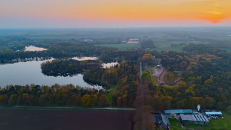 netherlands sunset aerial view. vibrant sunset over dutch landscapes with lakes, forests, and fields showcasing europe's natural beauty