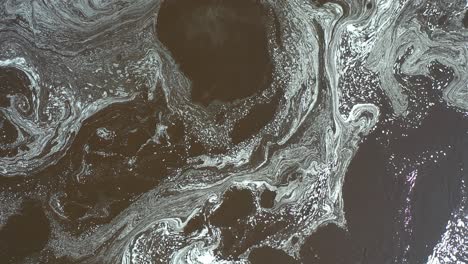 aerial view of changing patterns of foam on the surface of the water