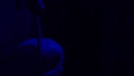 slow motion: inside a creepy haunted house during halloween with black lights and strobes, mannequins, skulls, clowns, evil rabbits, and spooky designs