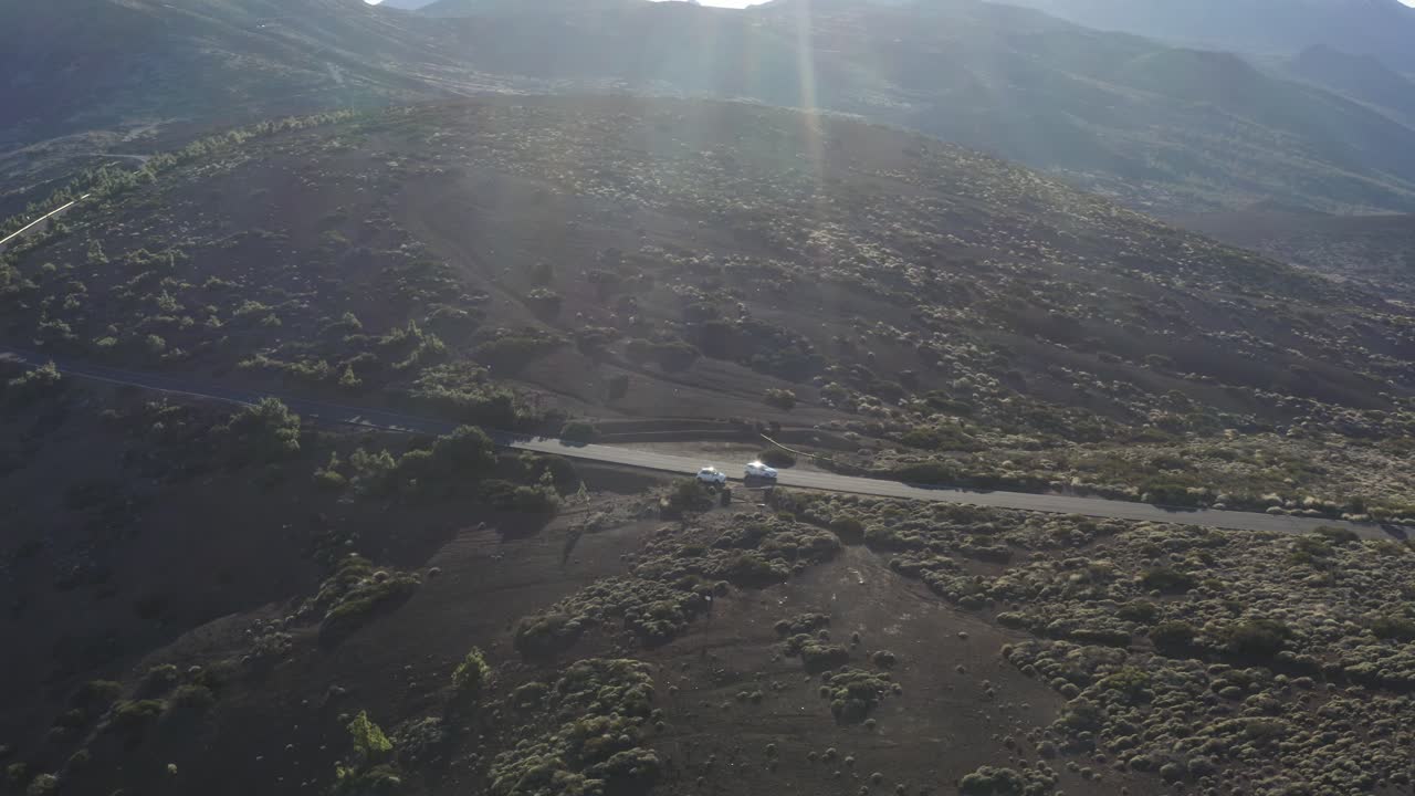 Gorgeous warming sun flare over remote Teide National Park. Canary Islands.  Drone panning left.