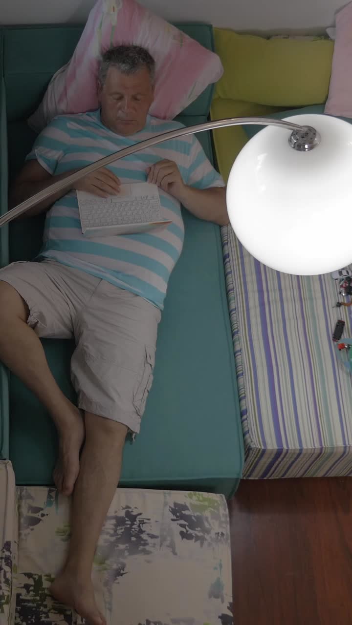 Man Sleeping on Couch with Keyboard