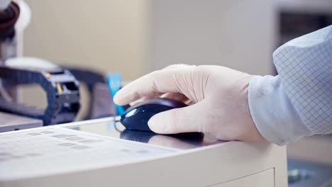 close up on a worker hand with glove working with a computer mouse