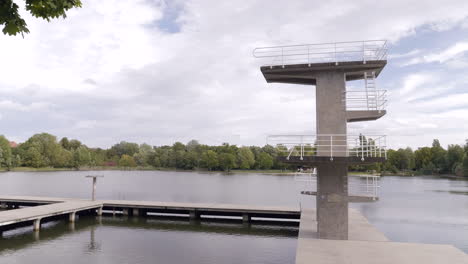 Diving-platform-from-the-left-side,-daylight,-autumn,-woog-outdoor-pool-lake-Darmstadt,-Hessen,-Germany