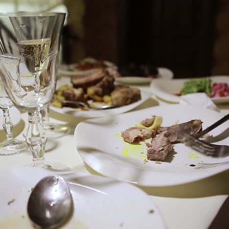 empty plates and wine glasses after a meal