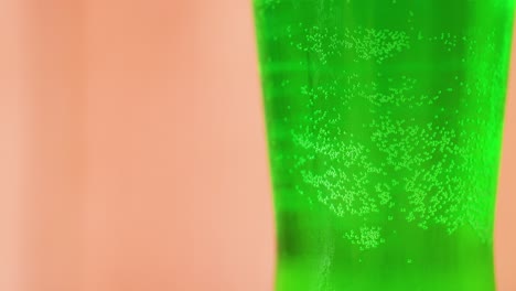 green liquid with bubbles in a glass