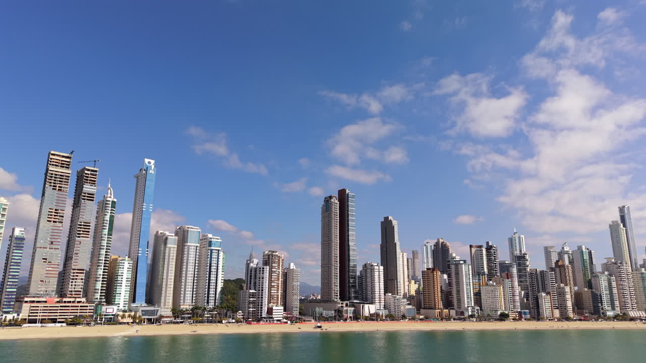 Drone shot of the modern high-rise skyline of Balneário Camboriú, Brazil, with beachfront towers along the coast