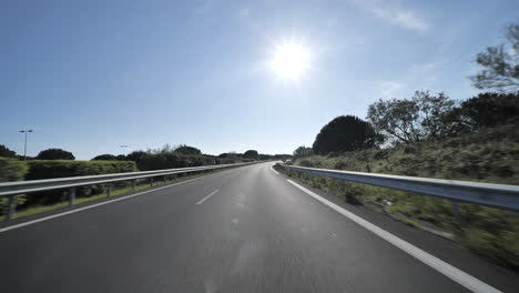 driving on empty highway with vegetation on the side france montpellier