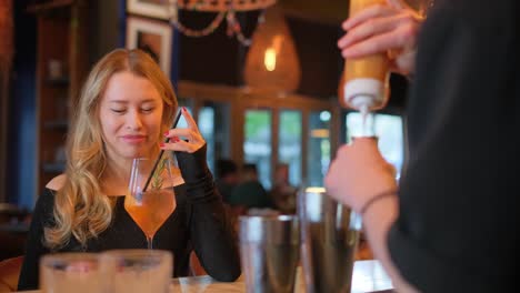 a young woman enjoys savoring her drink in a stylish bar, which embodies the true essence of modern nightlife