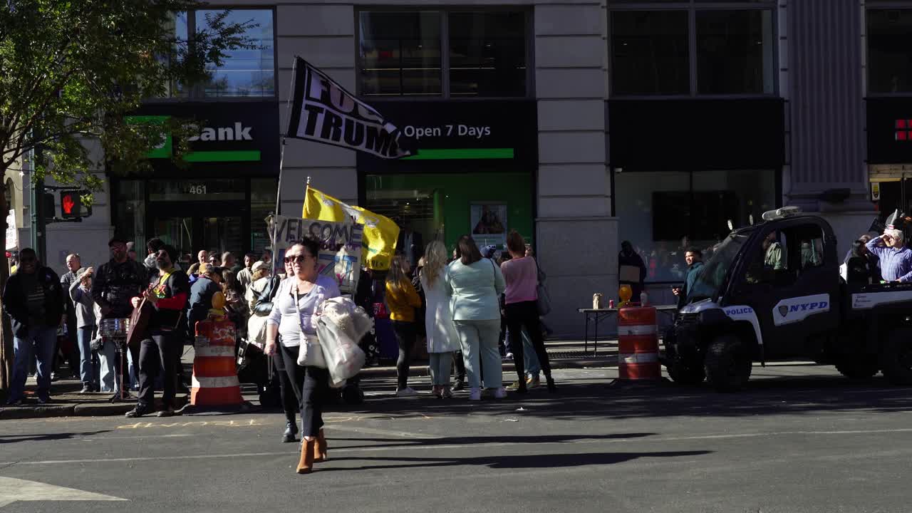 Protesters gather in the heart of New York, their energy palpable as they fill the streets around Madison Square Garden, demanding change against Trump under the bright sun