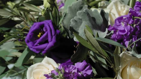 elegant white and purple flower bouquet for a brides wedding laid out for viewing