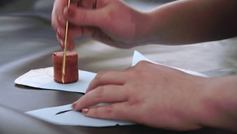 bespoke shoemaker measuring and cutting leather for shoe