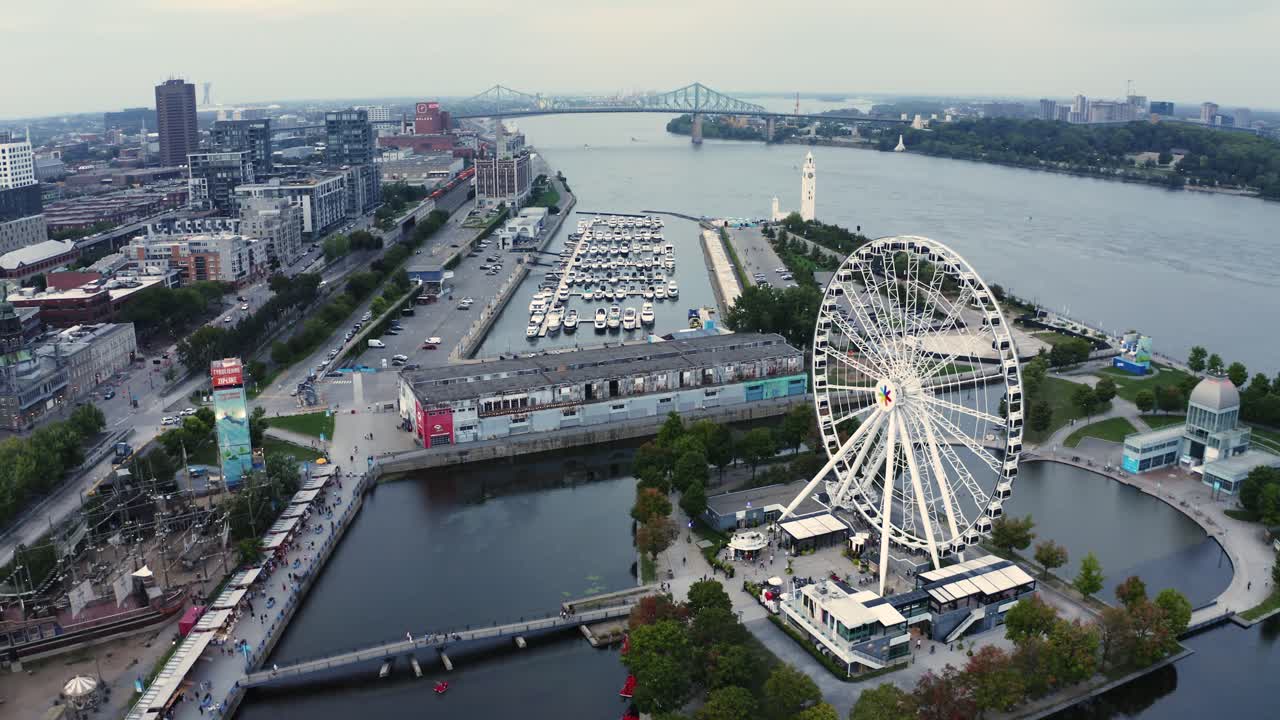 Aerial shot of Montreal's Old Port with the Ferris wheel in view, showcasing the vibrant waterfront and historic architecture. Perfect for capturing the essence of the city.