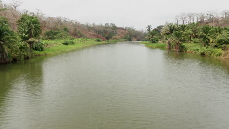 Traveling-front-over-a-river,-dam-on-a-river-in-Angola,-Africa-4