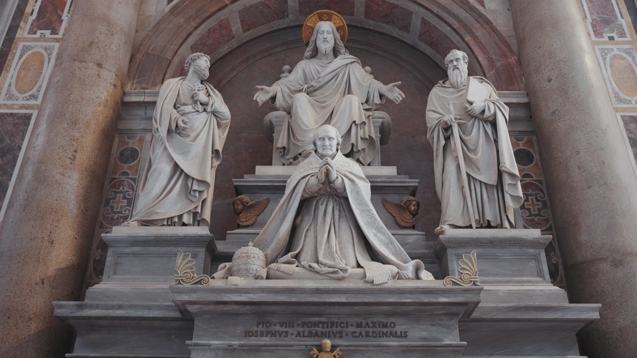 A grand marble monument inside St. Peter’s Basilica in the Vatican depicts religious figures and papal legacy, showcasing the artistry and devotion of Catholic tradition.