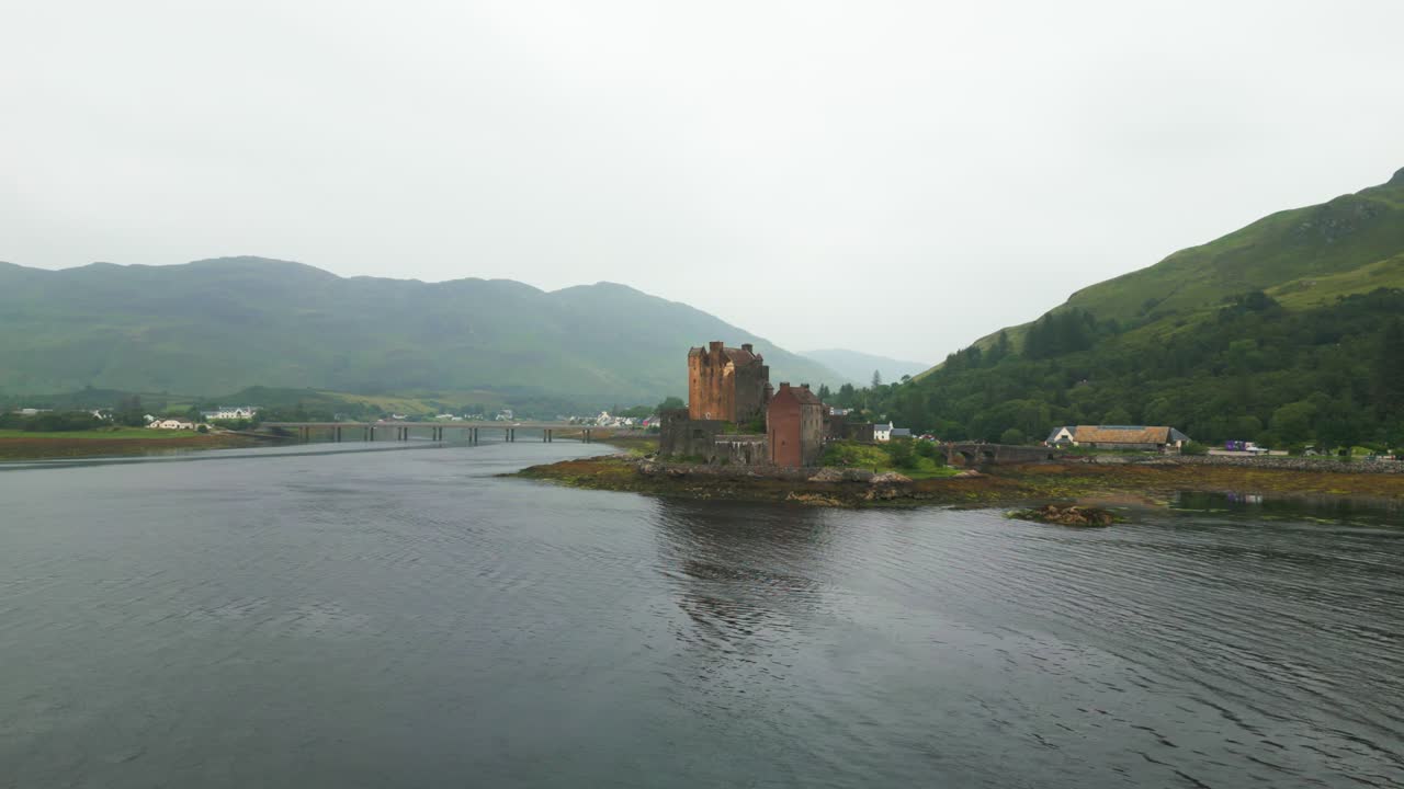Drove flies over Eilean Donan Castle in the Scottish Highlands from behind