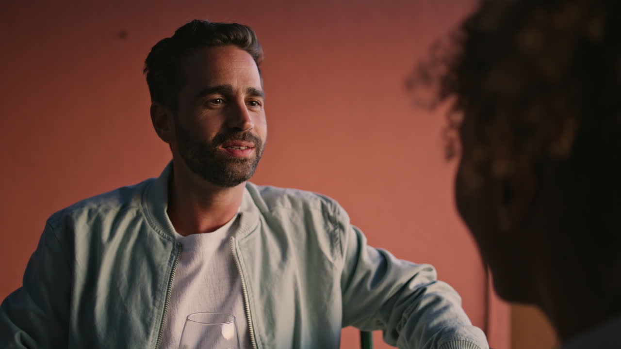 Two people communicating evening weekend closeup. o man listening woman